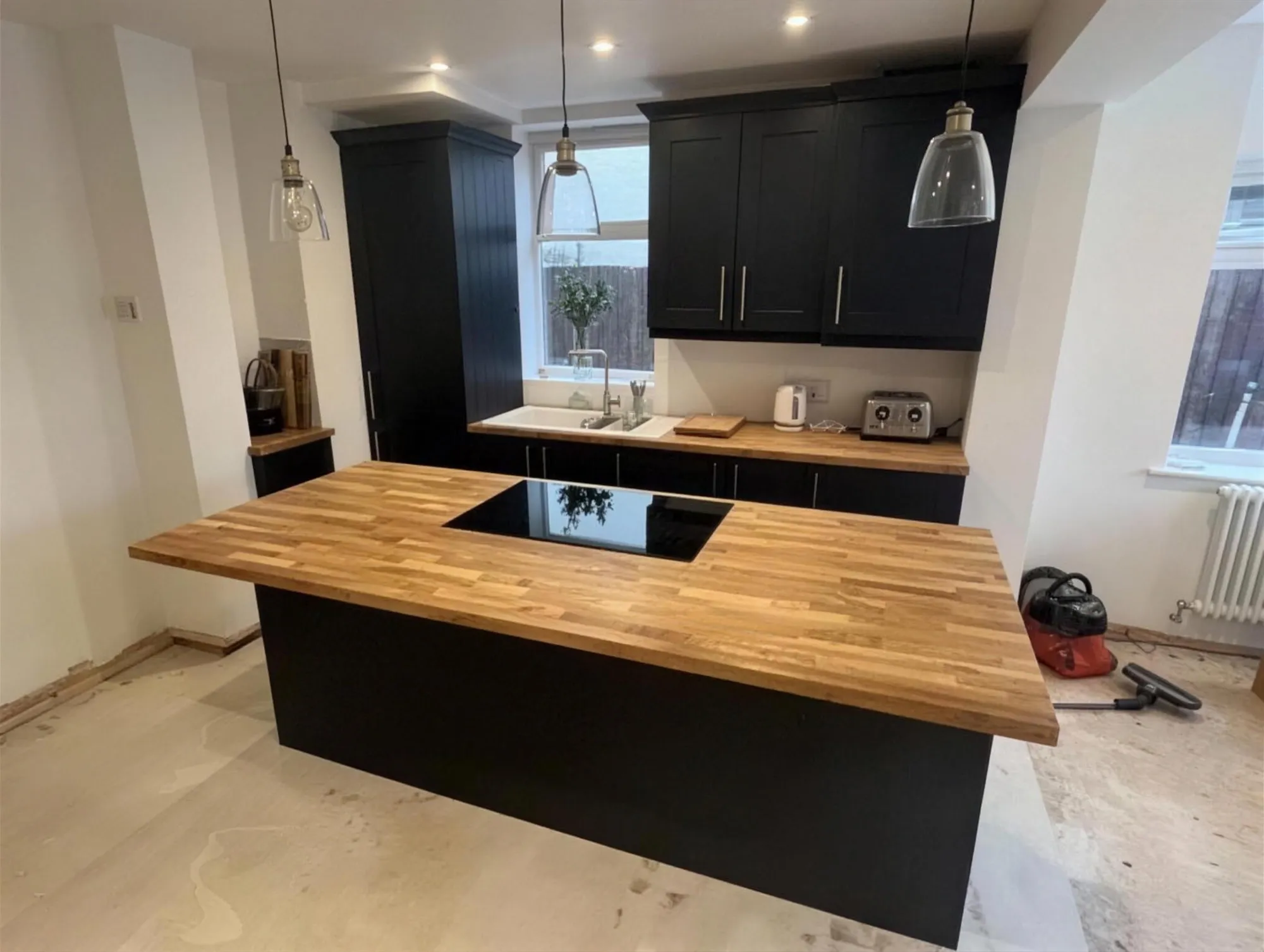 Kitchen island with solid oak worktop and navy units